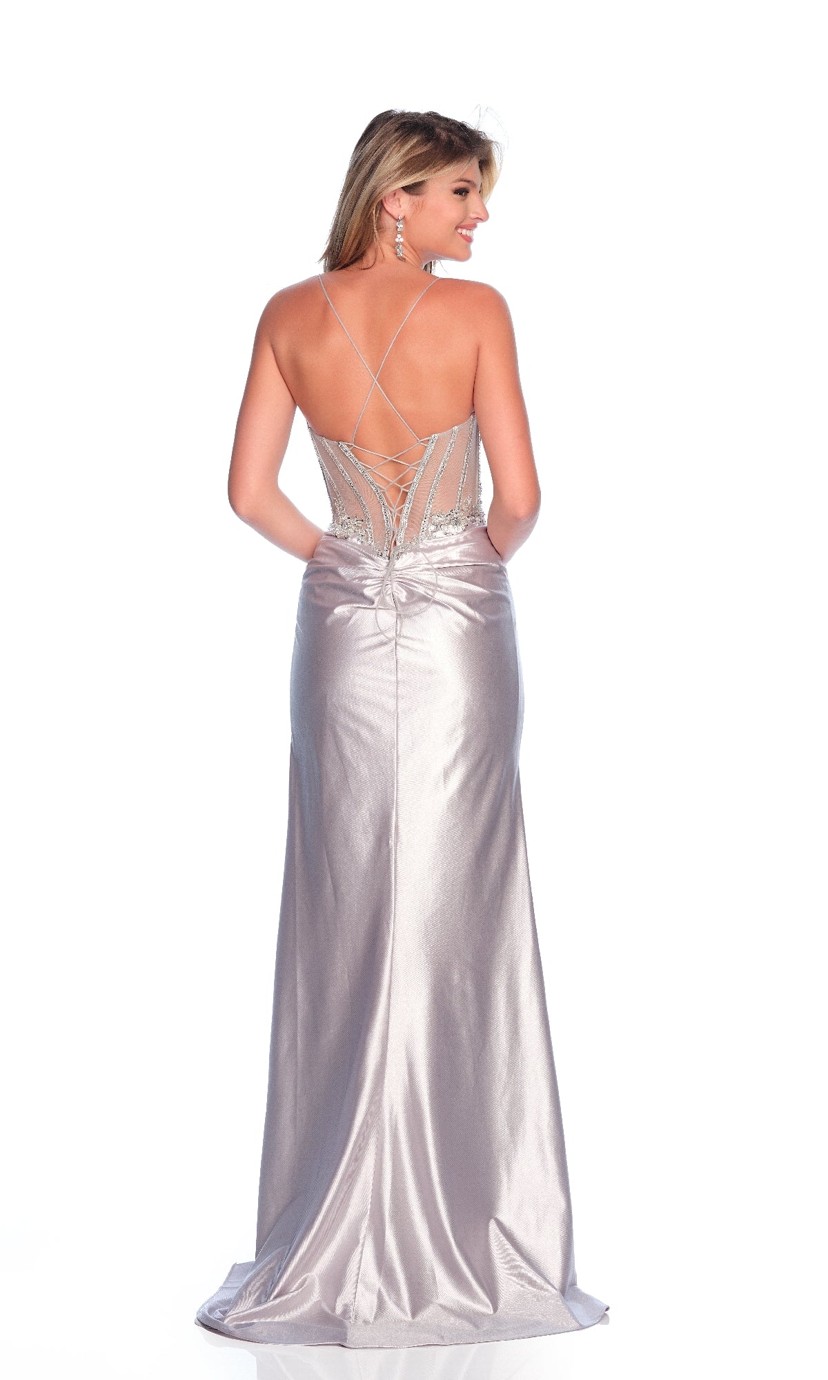 Woman wearing the Dave & Johnny 12239 Long Sleek Prom Dress featuring silver satin, a fitted sheer corset bodice, strappy open back, and beaded detailing, standing against a white background.